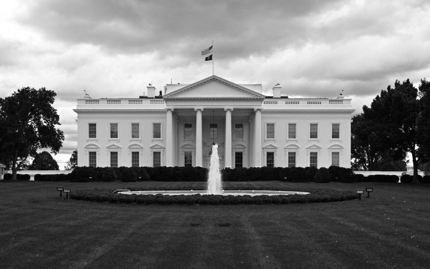 exterior photo of the White House with a fountain out front