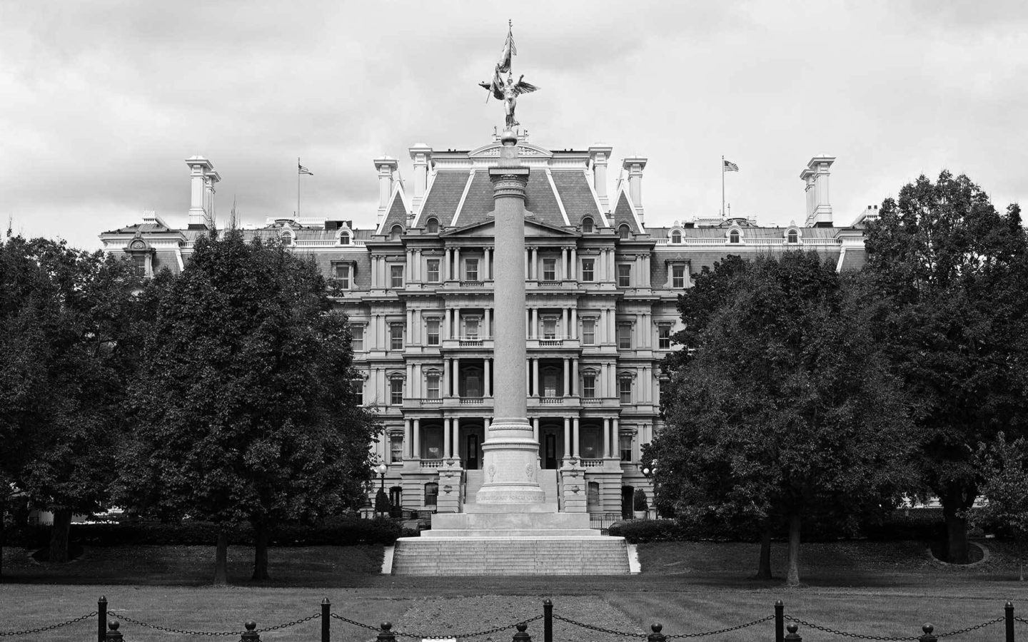 a statue on a lawn in front of an office building